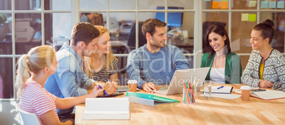 Group of young colleagues using laptop