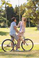 Young couple on a bike ride in the park