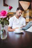 Young man reading a newspaper