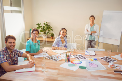 Casual businesswoman giving presentation to her colleagues