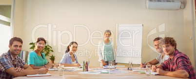 Casual businesswoman giving presentation to her colleagues