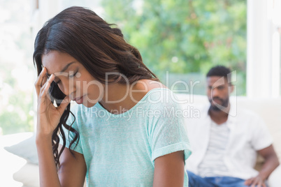 Couple not talking after a dispute on the sofa