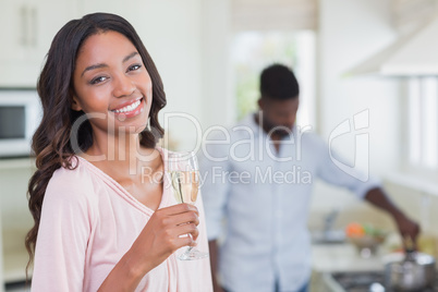 Happy woman having glass of champagne