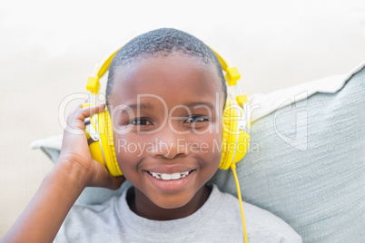 Little boy listening to music on the couch