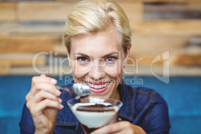 Smiling blonde holding a chocolate goblet