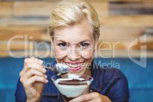 Smiling blonde holding a chocolate goblet