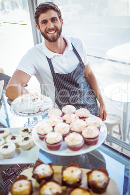 Smiling worker posing behind the counter