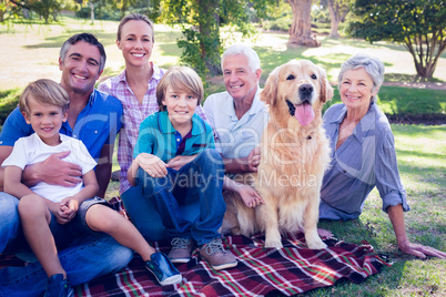 Happy family smiling at the camera with their dog Happy family smiling at the camera with their dog