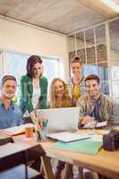 Portrait of smiling casual colleagues using computer