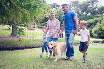Happy family in the park with their dog
