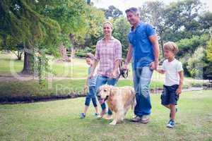 Happy family in the park with their dog