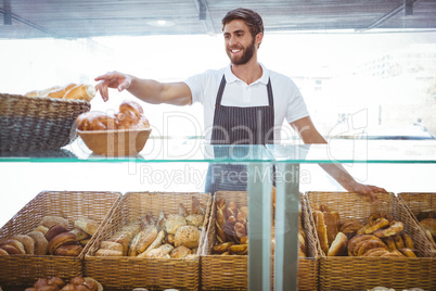 Smiling worker posing behind the counter