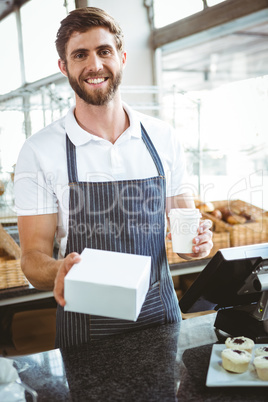 Smiling worker prepares orders