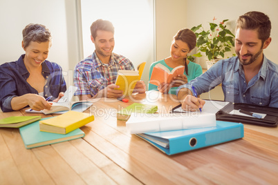 Group of colleagues reading books