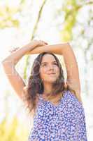 Pretty brunette standing arms raised