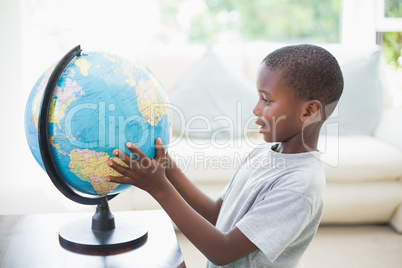 Little boy looking at the globe