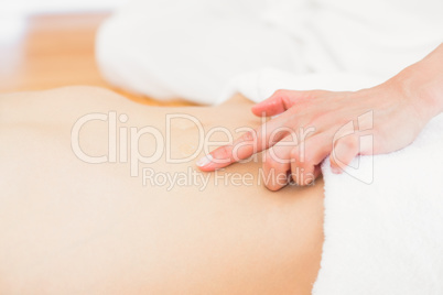 Pretty blonde enjoying a massage smiling at camera