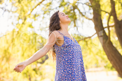 Pretty brunette feeling free in the park