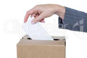 Businessman putting ballot in vote box