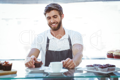 Smiling worker prepares breakfast
