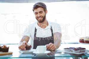 Smiling worker prepares breakfast