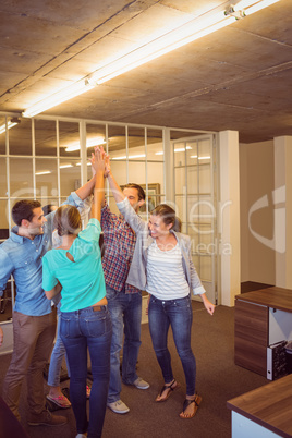 Creative business team raising their hands