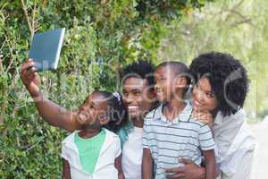 Happy family taking selfie with tablet pc
