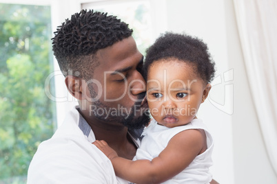 Happy father with baby girl on couch