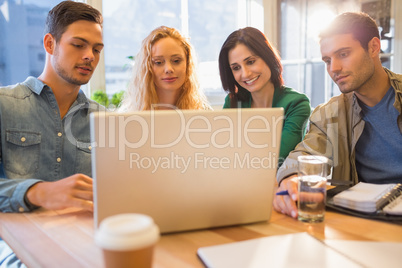 Group of young colleagues using laptop