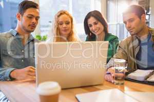 Group of young colleagues using laptop