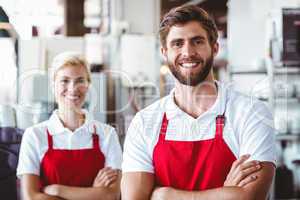 Two baristas smiling at the camera
