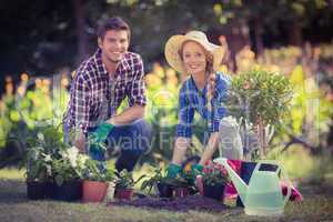 Happy young couple gardening together