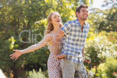 Young couple on a bike ride in the park