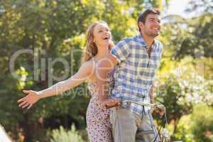 Young couple on a bike ride in the park