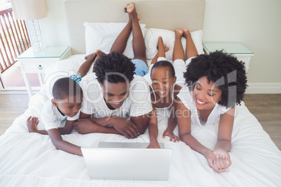 Happy family using the laptop together