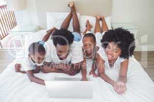 Happy family using the laptop together