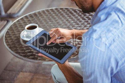 Attentive businessman using a tablet