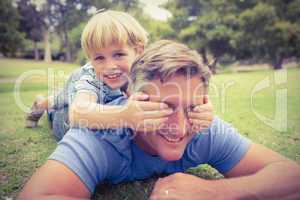 Happy father and his son smiling at camera