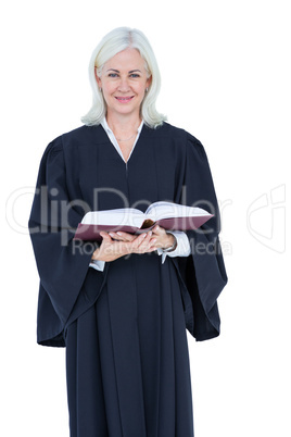 Happy lawyer looking at camera and holding law code