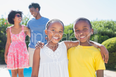 Happy siblings smiling at camera