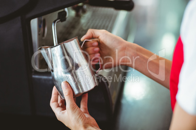 A barista using the coffee machine