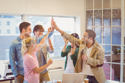 Happy business team doing hands checks