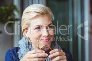 Smiling blonde enjoying a muffin cake