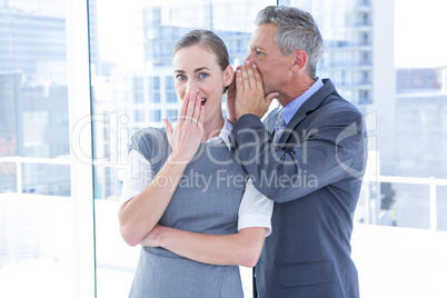 Secretive business colleagues whispering