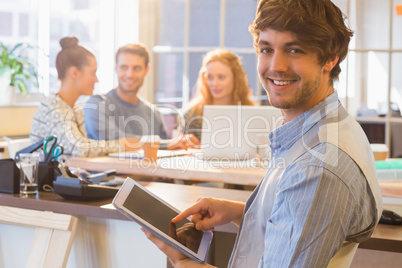 Smiling young man using digital tablet