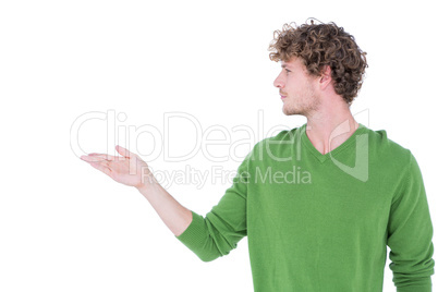 Handsome man holding something in front of camera