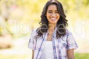 Pretty brunette looking at camera in the park