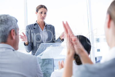 Business team applauding their colleague