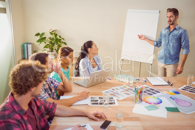 Casual businessman giving presentation to his colleagues