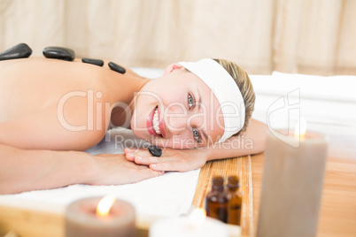 Beautiful blonde enjoying a hot stone massage